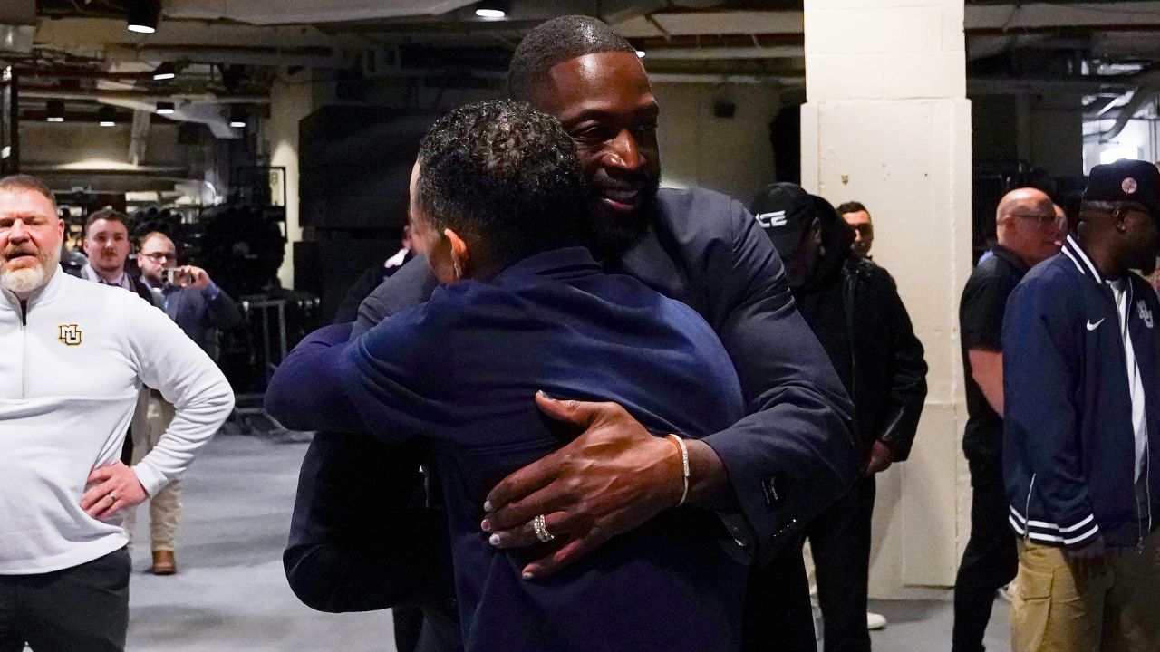 Former NBA player Dwayne Wade hugs Marquette Golden Eagles head coach Shaka Smart after defeating the Xavier Musketeers 89-87, Thursday, March 13, 2025, at Madison Square Garden in New York City.