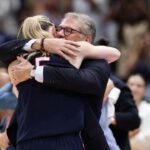 Connecticut Huskies head coach Geno Auriemma hugs guard Paige Bueckers (5) during the second half against the South Carolina Gamecocks of the national championship of the women's 2025 NCAA tournament at Amalie Arena