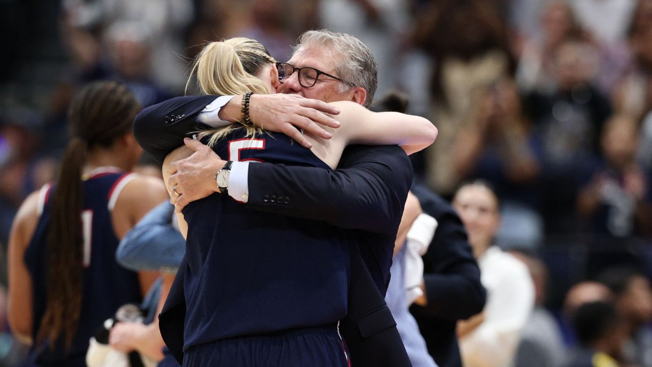 Connecticut Huskies head coach Geno Auriemma hugs guard Paige Bueckers (5) during the second half against the South Carolina Gamecocks of the national championship of the women's 2025 NCAA tournament at Amalie Arena