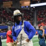 Former Auburn and NFL star Cam Newton stands on the sidelines during the Cricket Celebration Bowl game between Florida A&M University and Howard University at Mercedes-Benz Stadium in Atlanta on Dec. 16, 2023.