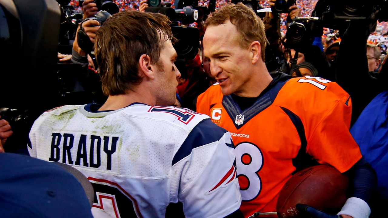 New England Patriots quarterback Tom Brady (12) and Denver Broncos quarterback Peyton Manning (18) shake hands after the game in the AFC Championship football game at Sports Authority Field at Mile High.