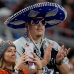 A Cincinnati Bengals fan and a Dallas Cowboys fan watch their teams take the field for Monday Night Football at AT&T Stadium in Arlington,Texas on Monday, December 9, 2024.