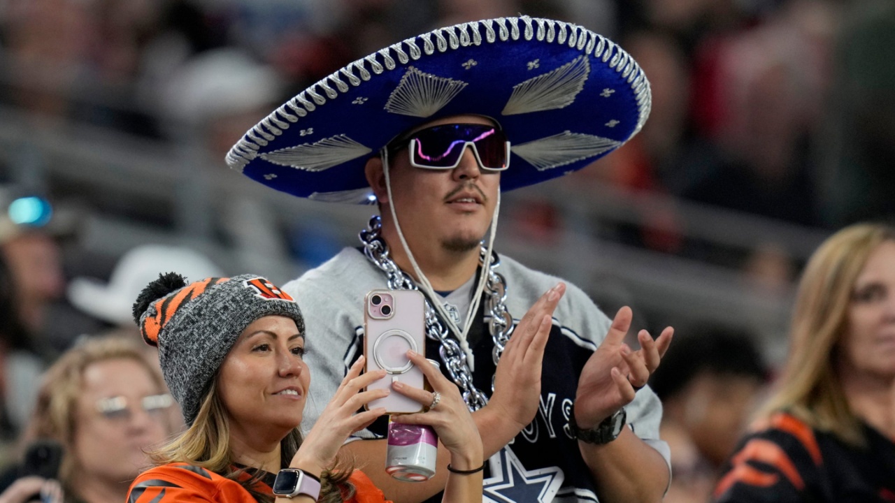 A Cincinnati Bengals fan and a Dallas Cowboys fan watch their teams take the field for Monday Night Football at AT&T Stadium in Arlington,Texas on Monday, December 9, 2024.