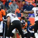 Baltimore Ravens linebacker Ray Lewis (52) calls a play against Denver Broncos quarterback Peyton Manning (18) during the AFC divisional round playoff game at Sports Authority Field. The Ravens defeated the Broncos 38-35 in double overtime.