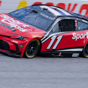 Apr 6, 2025; Darlington, South Carolina, USA; NASCAR Cup Series driver Denny Hamlin (11) in turn one during the Goodyear 400 at Darlington Raceway. Mandatory Credit: Jim Dedmon-Imagn Images