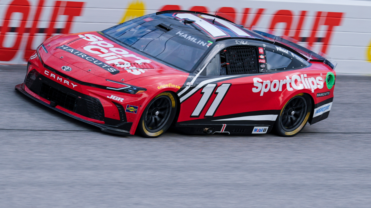 Apr 6, 2025; Darlington, South Carolina, USA; NASCAR Cup Series driver Denny Hamlin (11) in turn one during the Goodyear 400 at Darlington Raceway. Mandatory Credit: Jim Dedmon-Imagn Images