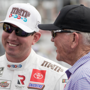 May 29, 2021; Concord, North Carolina, USA; NASCAR Cup Series driver Kyle Busch (18) talks with team owner Joe Gibbs (right) talk during qualifying for the Coca-Cola 600 at Charlotte Motor Speedway. Mandatory Credit: Jim Dedmon-Imagn Images