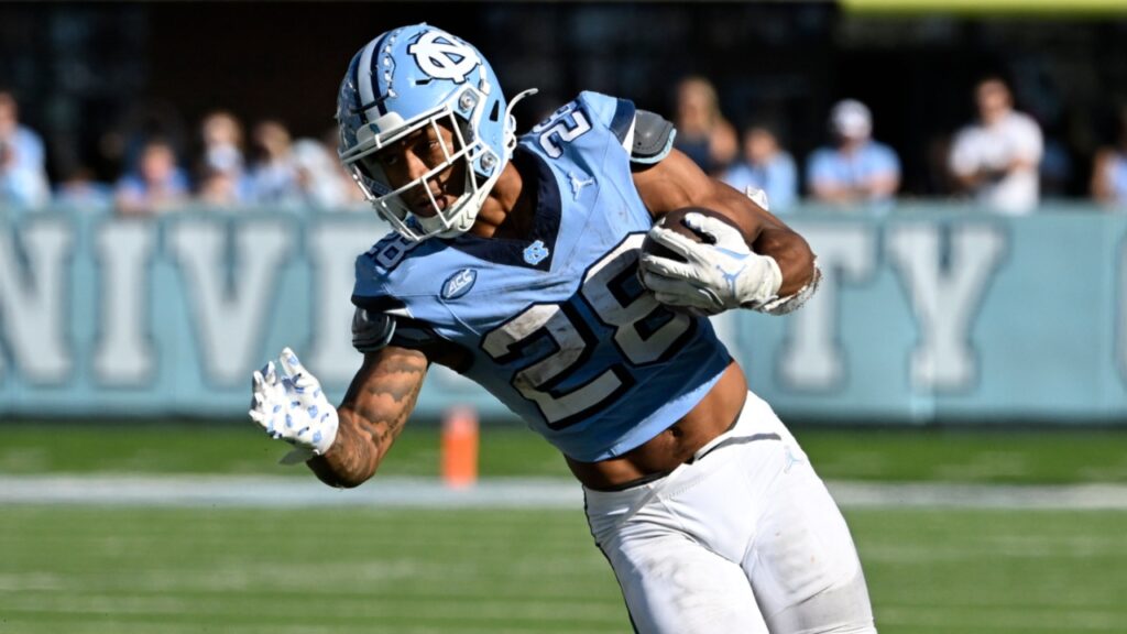 North Carolina Tar Heels running back Omarion Hampton (28) with the ball as Georgia Tech Yellow Jackets defensive back Warren Burrell (4) defends in the fourth quarter at Kenan Memorial Stadium.