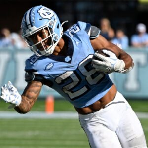 North Carolina Tar Heels running back Omarion Hampton (28) with the ball as Georgia Tech Yellow Jackets defensive back Warren Burrell (4) defends in the fourth quarter at Kenan Memorial Stadium.