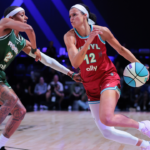 Mar 17, 2025; Miami, FL, USA; Vinyl BC guard Rae Burrell (12) drives to the basket against Rose BC guard Brittney Sykes (20) in the second quarter during the Unrivaled Championship game at Wayfair Arena.