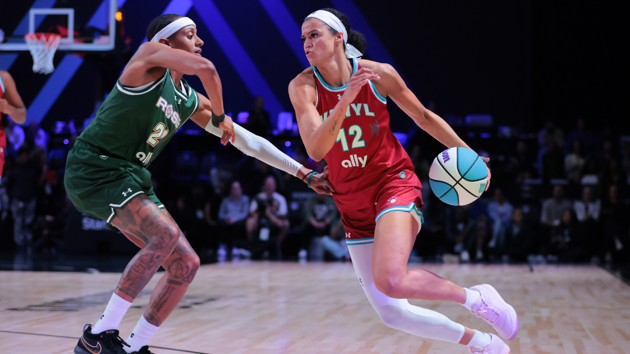 Mar 17, 2025; Miami, FL, USA; Vinyl BC guard Rae Burrell (12) drives to the basket against Rose BC guard Brittney Sykes (20) in the second quarter during the Unrivaled Championship game at Wayfair Arena.