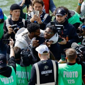 Former Colorado Buffaloes players Shedeur Sanders (L) and Travis Hunter (R) during their number retirement ceremony before the spring game at Folsom Field.