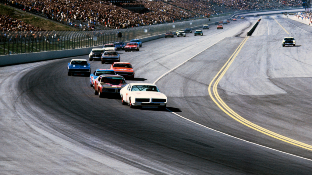 Feb 28, 1971; Ontario, CA, USA; FILE PHOTO; NASCAR Grand National Series driver Buddy Baker (11) leads the field into turn one at the 1971 Miller High Life 500 at Ontario Motor Speedway. Mandatory Credit: Darryl Norenberg-Imagn Images