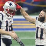 New England Patriots quarterback Tom Brady (12) celebrates with wide receiver Julian Edelman (11) after defeating the Los Angeles Rams in Super Bowl LIII at Mercedes-Benz Stadium.