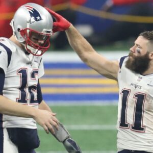 New England Patriots quarterback Tom Brady (12) celebrates with wide receiver Julian Edelman (11) after defeating the Los Angeles Rams in Super Bowl LIII at Mercedes-Benz Stadium.