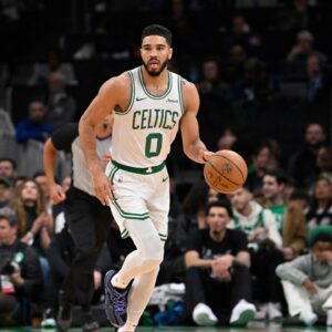 Boston Celtics forward Jayson Tatum (0) dribbles the ball against the Charlotte Hornets during the first half at TD Garden