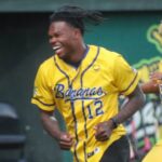 Heisman trophy winner Travis Hunter runs off the field after dancing with the Bananas during the Savannah Bananas game on Friday, April 11, 2025 at Historic Grayson Stadium.