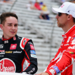 NASCAR Cup Series driver Christopher Bell (20) and NASCAR Cup Series driver Denny Hamlin (11) ride to pit road before the start of the Quaker State 400 at Atlanta Motor Speedway.