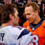 New England Patriots quarterback Tom Brady (12) and Denver Broncos quarterback Peyton Manning (18) shake hands after the game in the AFC Championship football game at Sports Authority Field at Mile High.