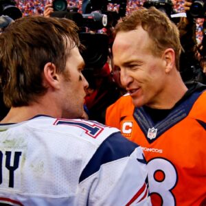 New England Patriots quarterback Tom Brady (12) and Denver Broncos quarterback Peyton Manning (18) shake hands after the game in the AFC Championship football game at Sports Authority Field at Mile High.