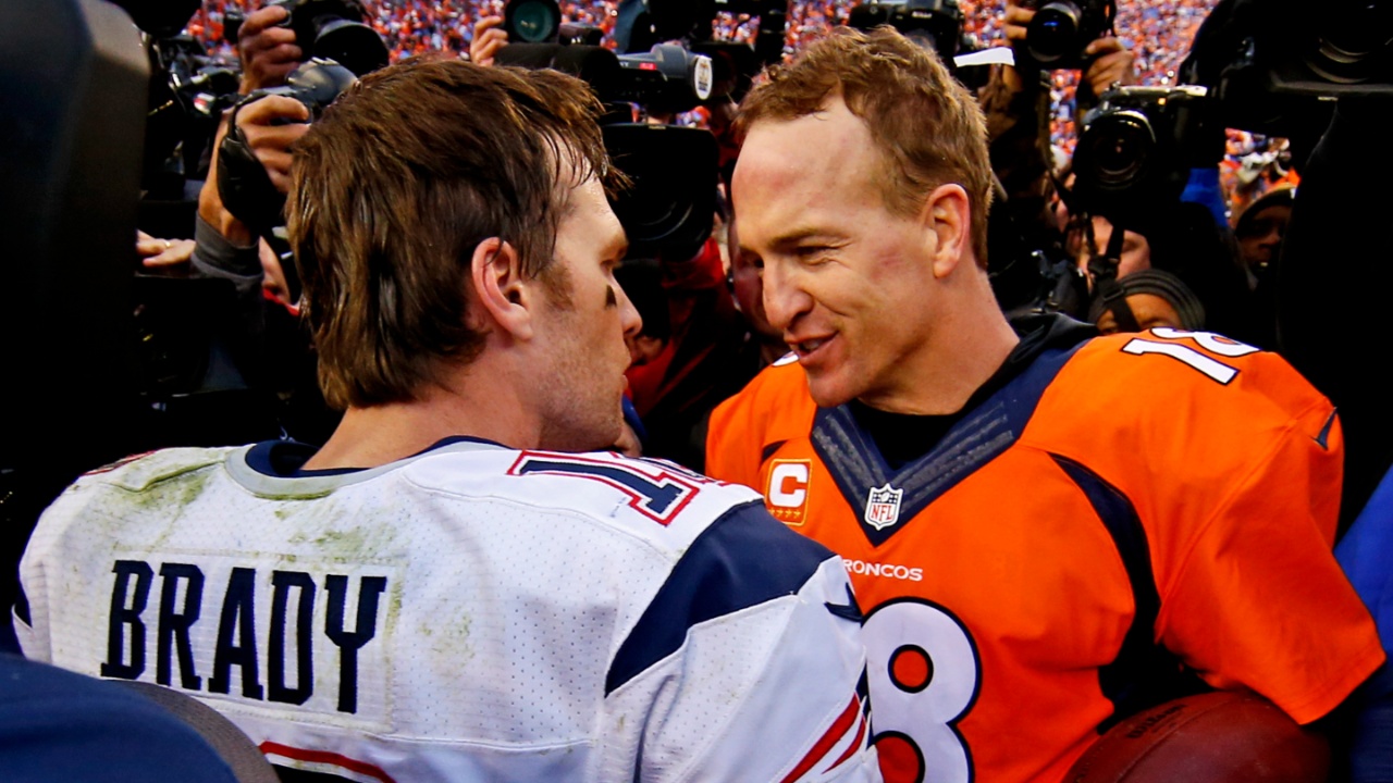 New England Patriots quarterback Tom Brady (12) and Denver Broncos quarterback Peyton Manning (18) shake hands after the game in the AFC Championship football game at Sports Authority Field at Mile High.