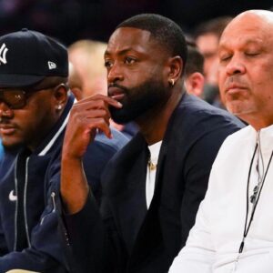 Former NBA player Dwayne Wade watches the NCAA Big East Conference Tournament quarterfinals game between the Xavier Musketeers and Marquette Golden Eagles