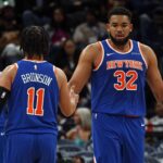 New York Knicks center Karl-Anthony Towns (32) reacts with guard Jalen Brunson (11) during the third quarter against the Memphis Grizzlies at FedExForum.