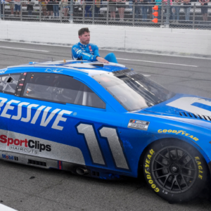 Mar 30, 2025; Martinsville, Virginia, USA; NASCAR Cup Series driver Denny Hamlin (11) gets out of his car after his win at the Cook Out 400 at Martinsville Speedway. Mandatory Credit: Jim Dedmon-Imagn Images