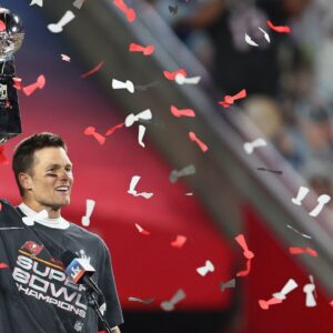 Tampa Bay Buccaneers quarterback Tom Brady (12) hoists the Vince Lombardi Trophy after defeating the Kansas City Chiefs in Super Bowl LV at Raymond James Stadium.