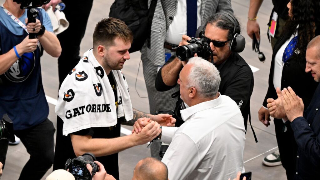 Los Angeles Lakers guard Luka Doncic (77) hugs his father Sasa Doncic after the game against the Dallas Mavericks at the American Airlines Center.