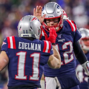 New England Patriots quarterback Tom Brady (12) and New England Patriots receiver Julian Edelman (11) celebrate after a touchdown during the first half against the Kansas City Chiefs at Gillette Stadium.