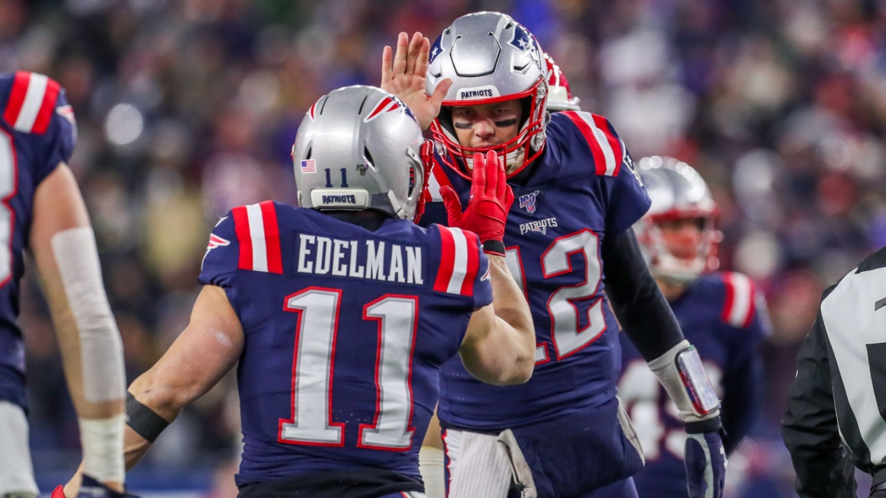 New England Patriots quarterback Tom Brady (12) and New England Patriots receiver Julian Edelman (11) celebrate after a touchdown during the first half against the Kansas City Chiefs at Gillette Stadium.