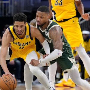 Milwaukee Bucks guard Damian Lillard (0) defends against Indiana Pacers guard Tyrese Haliburton (0) in the second half during game three of first round for the 2024 NBA Playoffs at Fiserv Forum.