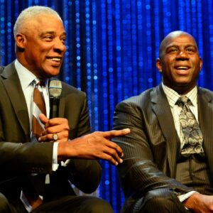 NBA legend Julius Erving speaks while Magic Johnson looks on during the NBA All-Star Game Legends Brunch at Ernest N. Morial Convention Center.