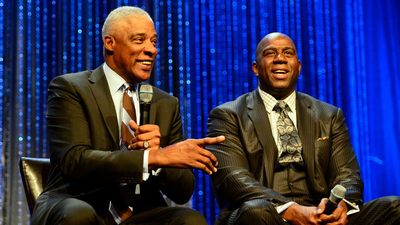 NBA legend Julius Erving speaks while Magic Johnson looks on during the NBA All-Star Game Legends Brunch at Ernest N. Morial Convention Center.