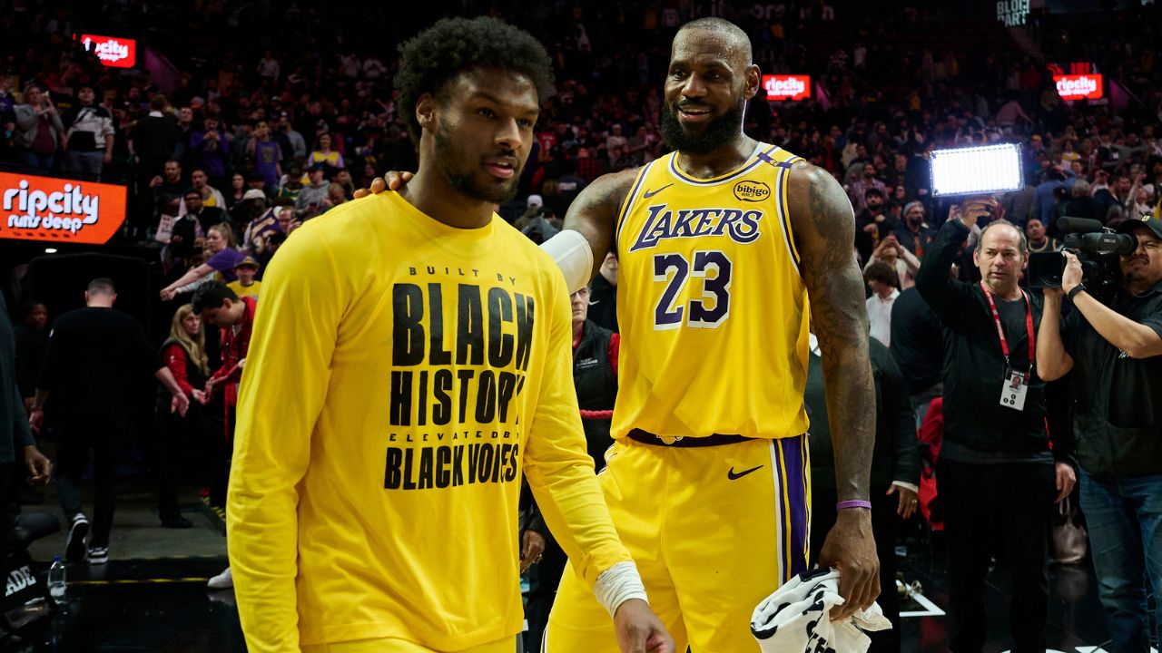 Los Angeles Lakers forward LeBron James (23) celebrates victory over the Portland Trail Blazers with his son guard Bronny James (9) at Moda Center.