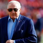 Dallas Cowboys owner Jerry Jones walks off the field before the game between the Washington Commanders and the Dallas Cowboys at Northwest Stadium.