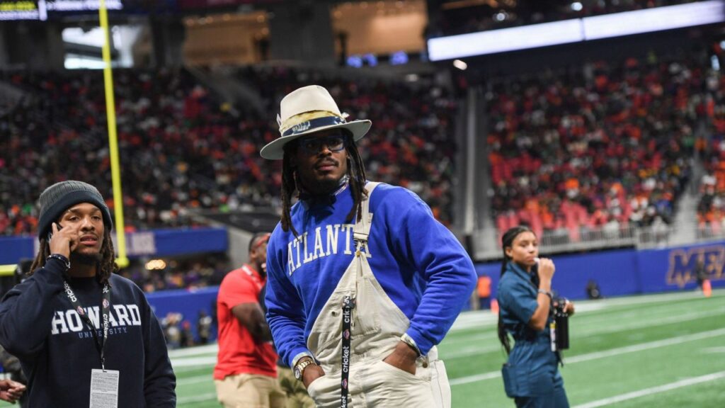 Former Auburn and NFL star Cam Newton stands on the sidelines during the Cricket Celebration Bowl game between Florida A&M University and Howard University at Mercedes-Benz Stadium in Atlanta on Dec. 16, 2023.