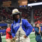 Former Auburn and NFL star Cam Newton stands on the sidelines during the Cricket Celebration Bowl game between Florida A&M University and Howard University at Mercedes-Benz Stadium in Atlanta on Dec. 16, 2023.