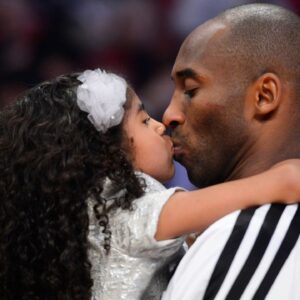 Western Conference guard Kobe Bryant (right) of the Los Angeles Lakers kisses his daughter Natalia Bryant at halftime of the 2013 NBA all star game at the Toyota Center.