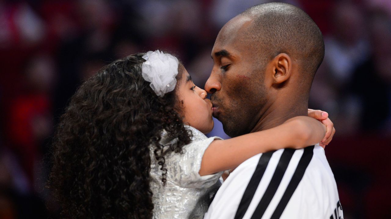 Western Conference guard Kobe Bryant (right) of the Los Angeles Lakers kisses his daughter Natalia Bryant at halftime of the 2013 NBA all star game at the Toyota Center.