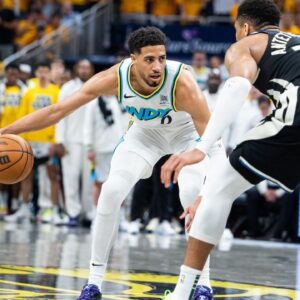 Indiana Pacers guard Tyrese Haliburton (0) dribbles the ball while Milwaukee Bucks forward Giannis Antetokounmpo (34) defends during game five of the first round for the 2024 NBA Playoffs at Gainbridge Fieldhouse.