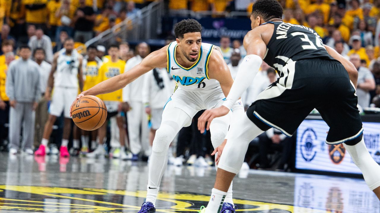 Indiana Pacers guard Tyrese Haliburton (0) dribbles the ball while Milwaukee Bucks forward Giannis Antetokounmpo (34) defends during game five of the first round for the 2024 NBA Playoffs at Gainbridge Fieldhouse.