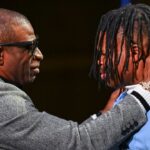 Colorado Buffaloes wide receiver/cornerback Travis Hunter with head coach Deion Sanders after winning the 2024 Heisman Trophy.