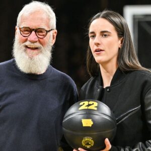 Former Iowa Hawkeyes player Caitlin Clark and comedian David Letterman react after the game at Carver-Hawkeye Arena against the USC Trojans. The Hawkeyes retired the jersey of Clark after the game.