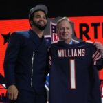 Southern California Trojans quarterback Caleb Williams holds up his jersey after being selected by the Chicago Bears as the No. 1 pick in the first round of the 2024 NFL Draft at Campus Martius Park and Hart Plaza.