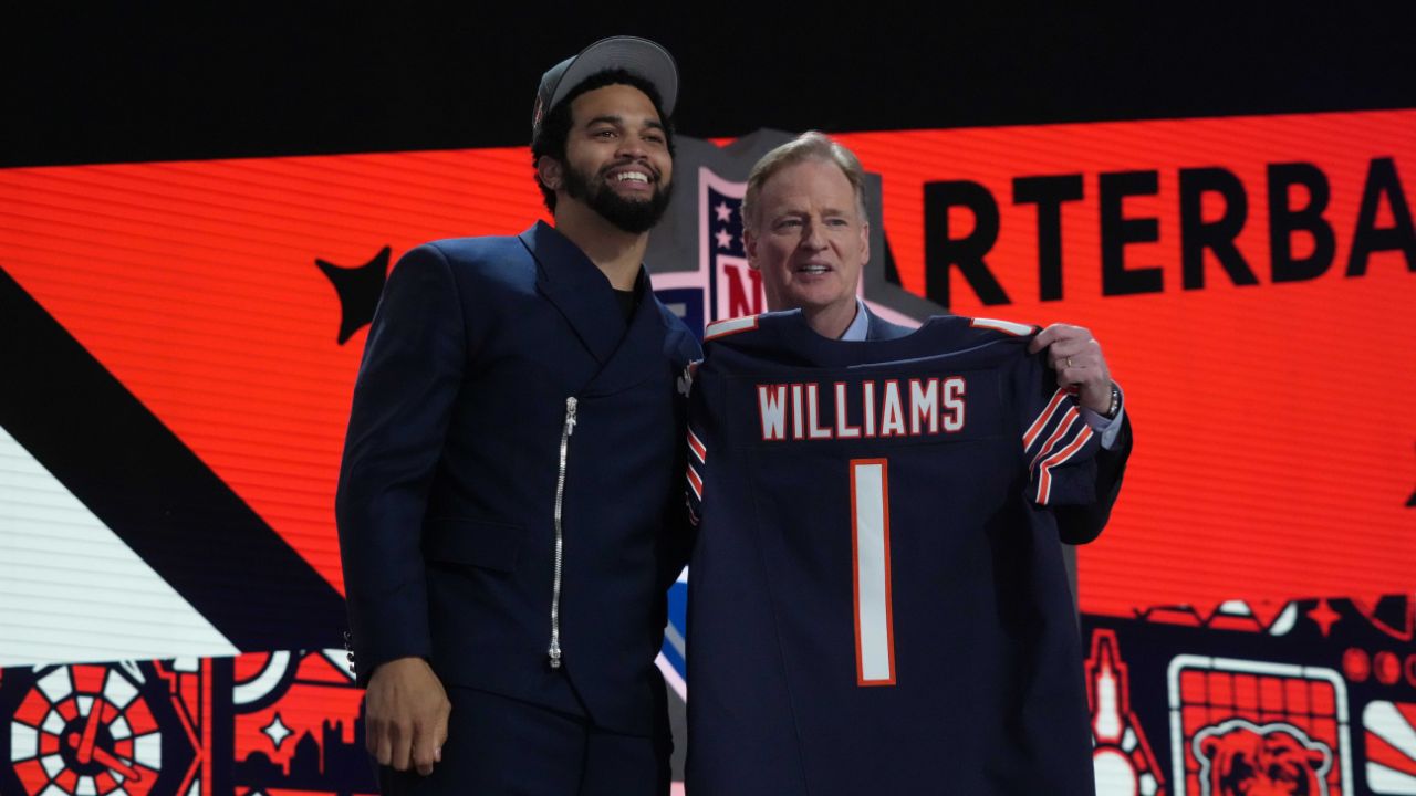 Southern California Trojans quarterback Caleb Williams holds up his jersey after being selected by the Chicago Bears as the No. 1 pick in the first round of the 2024 NFL Draft at Campus Martius Park and Hart Plaza.