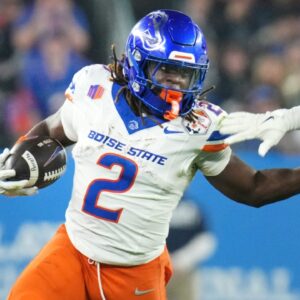 Boise State Broncos running back Ashton Jeanty (2) runs past Penn State Nittany Lions linebacker Kobe King (41) during their Vrbo Fiesta Bowl matchup at State Farm Stadium on Dec. 31, 2024.