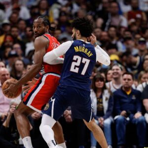 Los Angeles Clippers forward Kawhi Leonard (2) controls the ball as Denver Nuggets guard Jamal Murray (27) guards and center Nikola Jokic (15) defends in the third quarter during game two of first round for the 2025 NBA Playoffs at Ball Arena.