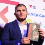 Coach Abdulmanap Nurmagomedov and Russian mixed martial artist, UFC lightweight champion Khabib Nurmagomedov during a press approach after an interview at the Synergy Global Forum business forum at the Olympic Sports Complex in Moscow.
